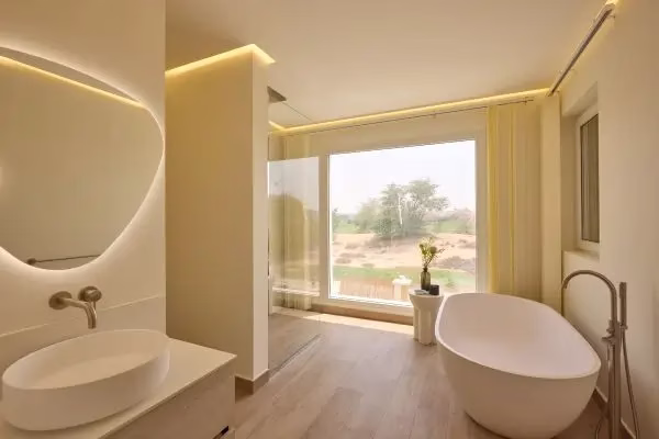 Spa-inspired master ensuite with natural stone finishes and freestanding bathtub – Ras Al Khaimah townhouse renovation