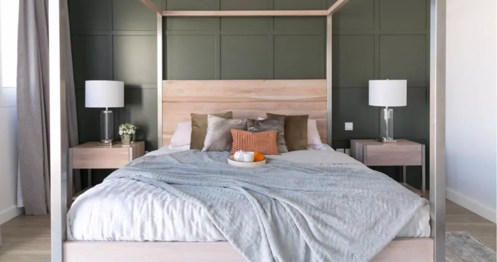 Cozy bedroom with white bedding, layered throws and cushions designed by Tunde Hendricks Design