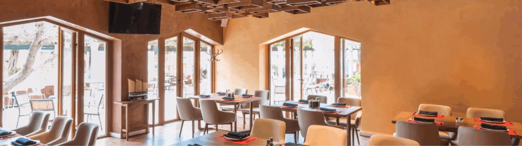 Modern restaurant interior designed by Tünde Hendricks Design in Ras Al Khaimah, featuring comfortable seating, ambient lighting, and a welcoming atmosphere.