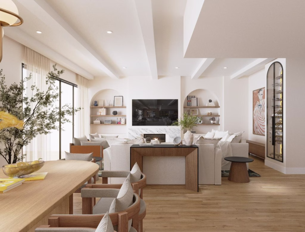 Looking through the open plan living space toward the arched media wall, highlighting spatial flow, natural wood flooring, and a sleek console table zoning the room.