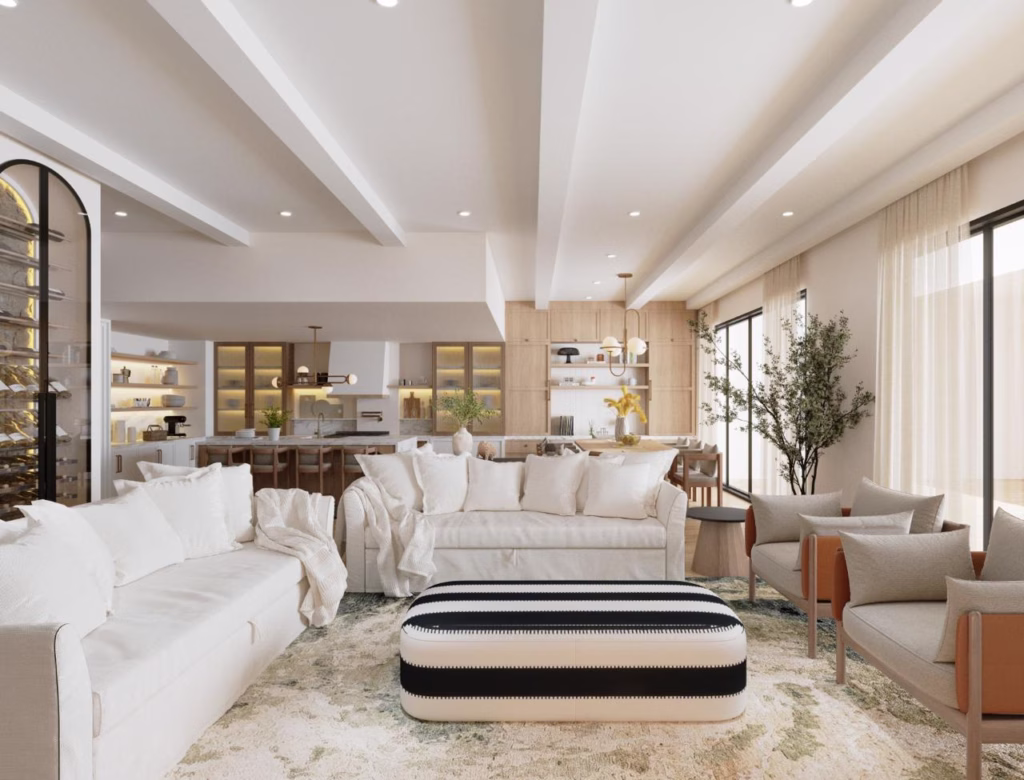Comprehensive view of the open plan ground floor at The Villa Barefoot, displaying the fluid transition between the lounge seating, dining table, and custom arched glass wine display.