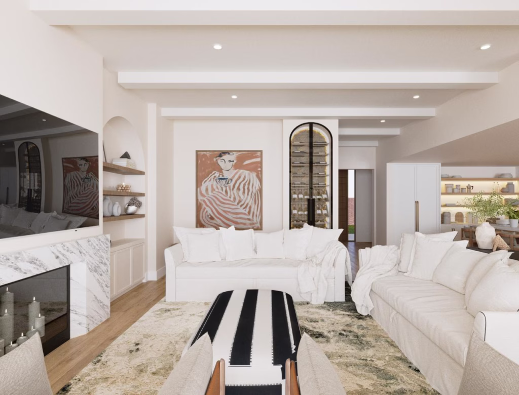 Warm minimalist living room lounge with a white sofa, marble fireplace, custom recessed architectural display arches, and black and white striped ottoman at The Villa Barefoot by Tünde Hendricks Design.